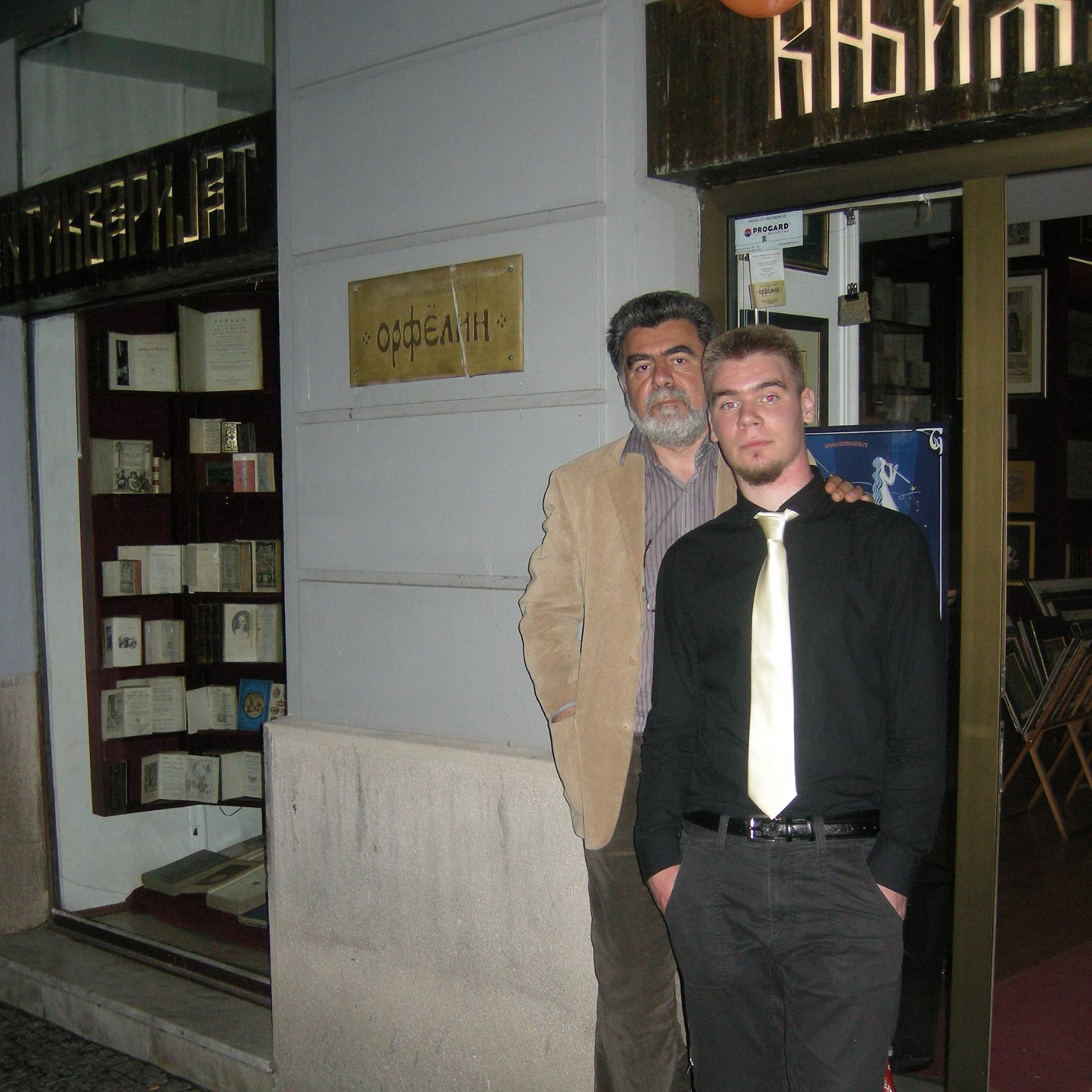 Predrag Milovanovic and his son in front of the antiquariat "Orfelin".
