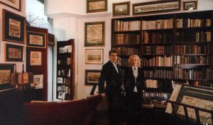 Predrag Milovanovic and his wife Vesna, surrounded by the old books and maps. 