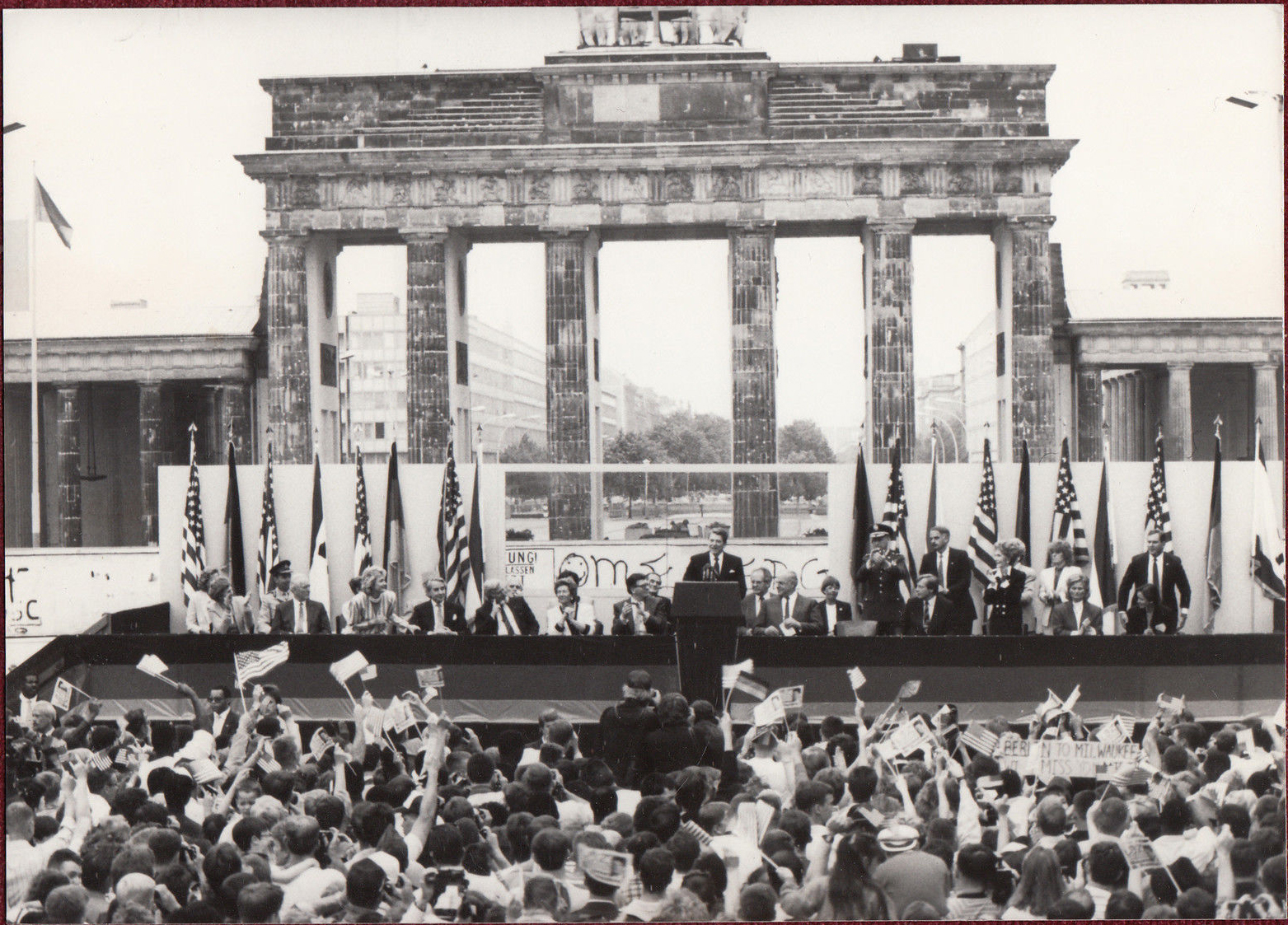 The US president Ronald Regan in front of the crowd with the Berlin Wall behind him. 