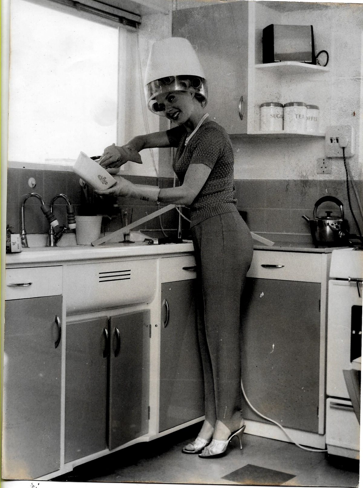 The image is showing Barbara Roscoe doing her hair and cooking.